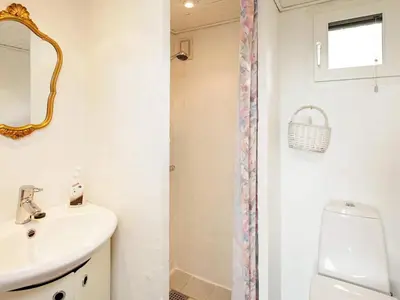 a bathroom with a sink and a toilet and a mirror at 4 person holiday home in Struer in Struer