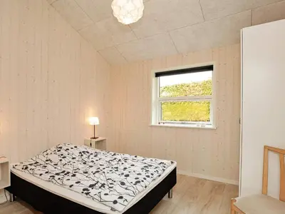 a bedroom with a bed and a window at 8 person holiday home in Roslev-By Traum in Roslev