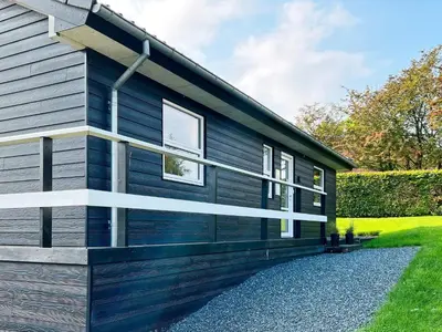 a house with blue siding on the side of it at 8 person holiday home in Roslev-By Traum in Roslev