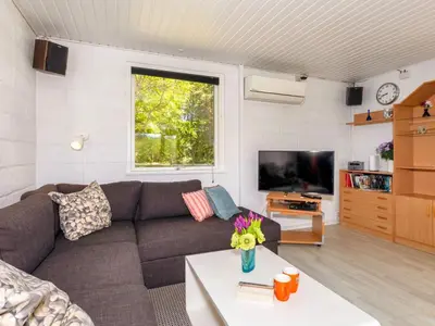 a living room with a couch and a tv at 5 person holiday home in Fur-By Traum in Fur