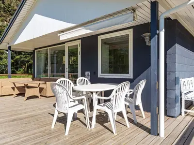 a patio with a table and chairs on a deck at 5 person holiday home in Fur-By Traum in Fur