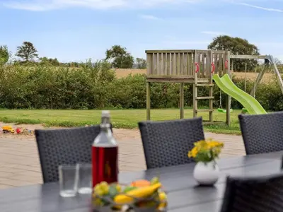 a table with a bottle of soda and fruit on it at Luxury Retreat by Hostrup Beach - By Traum Ferienwohnungen in Spottrup