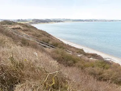 a train on a hill next to a beach at 8 person holiday home in Struer-By Traum in Struer