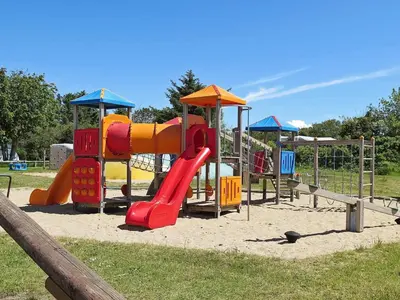 a playground with a slide in a park at 8 person holiday home in Struer-By Traum in Struer