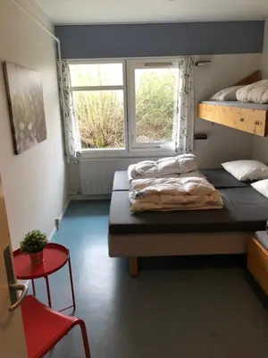 a bedroom with two bunk beds and a window at Danhostel Aalborg in Aalborg
