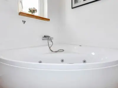 a white bath tub with a faucet in a bathroom at 8 person holiday home in Højslev-By Traum in Højslev