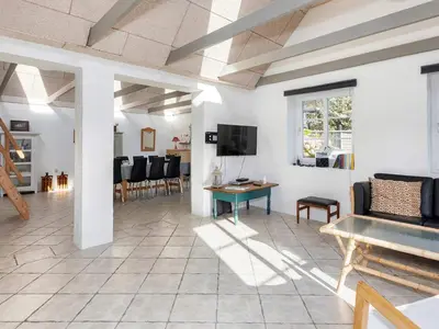 a living room with a couch and a table at 10 person holiday home in Fur-By Traum in Fur