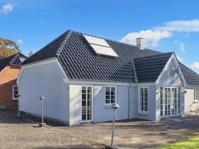 a white house with a black roof at 10 person holiday home in Fur-By Traum in Fur