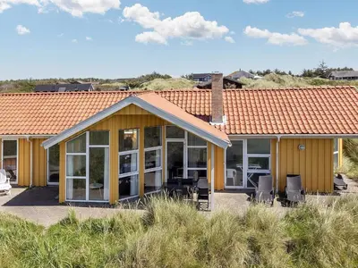 a house with glass doors and a roof at 10 person holiday home in Løkken in Løkken