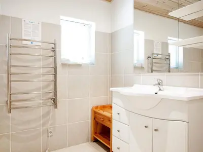 a white bathroom with a sink and a shower at 6 person holiday home in Thyholm in Thyholm