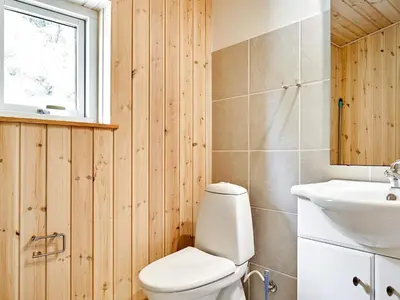 a bathroom with a toilet and a sink at 6 person holiday home in Thyholm in Thyholm
