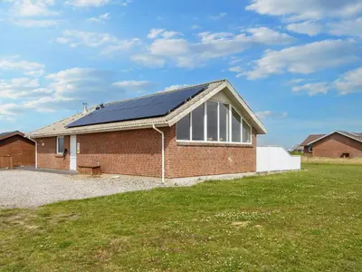 a brick house with solar panels on the roof at 12 person holiday home in Harboøre-By Traum in Harboør