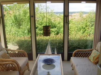 a living room with a couch and a glass table at Glyngøre Bed & Breakfast II in Glyngøre