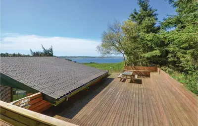 a wooden deck with a bench on top of a house at Three-Bedroom Holiday Home In Struer in Struer