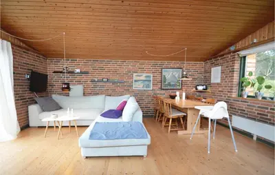 a living room with a couch and a table at Three-Bedroom Holiday Home In Struer in Struer