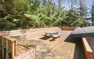 a wooden deck with a picnic table on it at Three-Bedroom Holiday Home In Struer in Struer