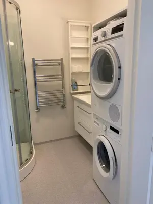 a laundry room with a washer and dryer at Strømpehuset in Øster Assels