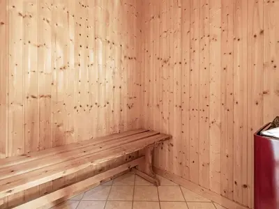 a wooden bench in a room with wooden walls at 8 person holiday home in Spøttrup in Spottrup