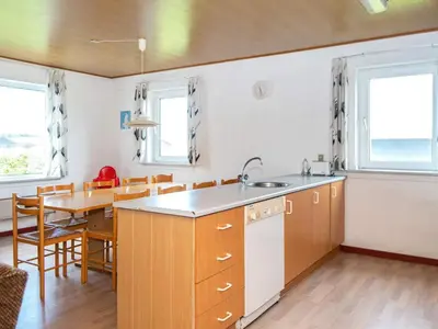 a kitchen and dining room with a table and chairs at 10 person holiday home in Harboøre-By Traum in Harboør