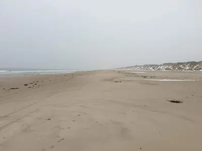 an empty beach with footprints in the sand at 10 person holiday home in Løkken-By Traum in Løkken
