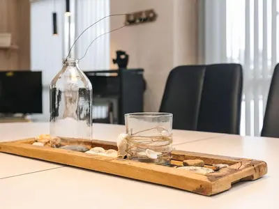 a tray with a bottle and a glass on a table at 10 person holiday home in Løkken-By Traum in Løkken