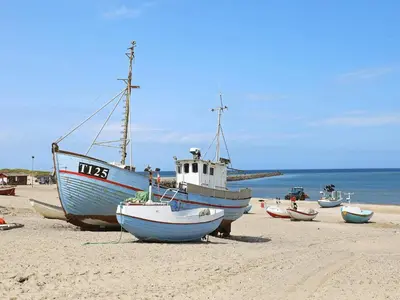 a group of boats sitting on the beach at 4 person holiday home in Thisted-By Traum in Nørre Vorupør