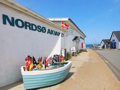 a boat on the side of a building with flags on it at 4 person holiday home in Thisted-By Traum in Nørre Vorupør