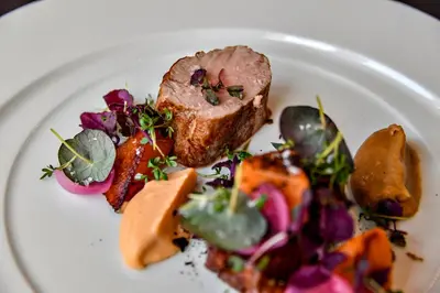 a plate of food with meat and vegetables on it at Hotel Thinggaard in Hurup