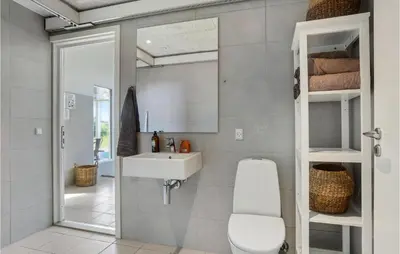 a bathroom with a sink and a toilet at Lovely Home In Blokhus With Sauna in Blokhus