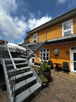a staircase leading up to a yellow building at Oasen in Viborg