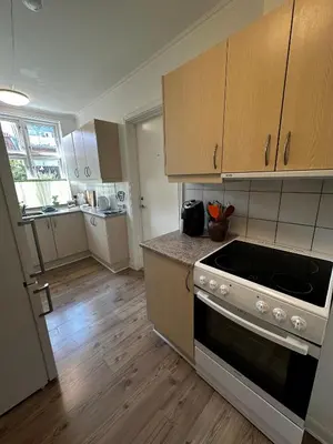 a kitchen with a stove and a counter top at Oasen in Viborg