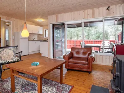 a living room with a table and a chair at 6 person holiday home in Thisted-By Traum in Torsted