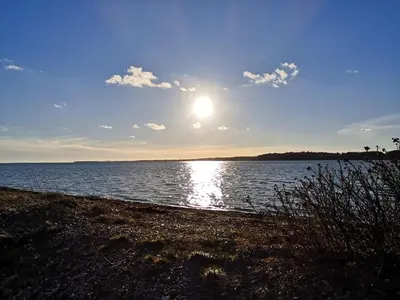 a sun setting over a large body of water at 8 person holiday home in Roslev-By Traum in Roslev
