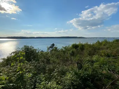 a view of a lake with a bridge in the distance at 8 person holiday home in Roslev-By Traum in Roslev