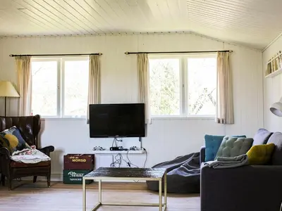 a living room with a couch and a tv at 8 person holiday home in Roslev-By Traum in Roslev