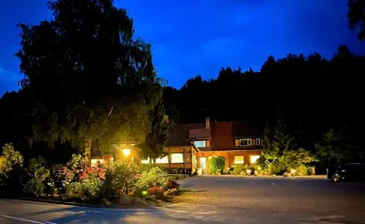 a house with a parking lot at night at Sallingsund Færgekro in Nykøbing Mors