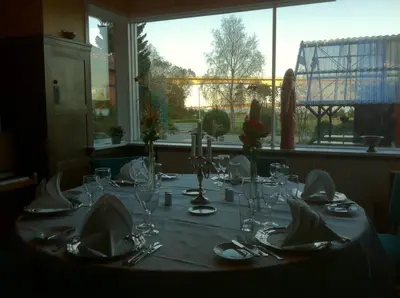 a table with glasses and napkins on top of it at Sallingsund Færgekro in Nykøbing Mors