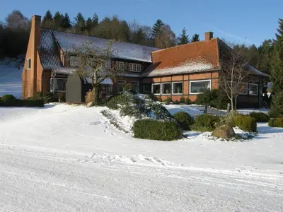 a house with snow in front of it at Sallingsund Færgekro in Nykøbing Mors