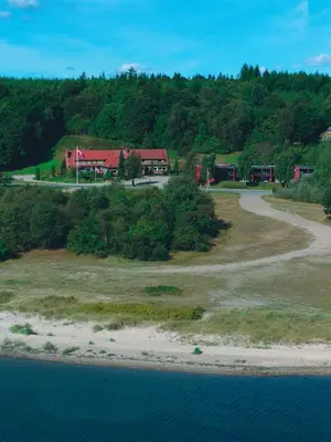 an aerial view of a house on a hill next to the water at Sallingsund Færgekro in Nykøbing Mors