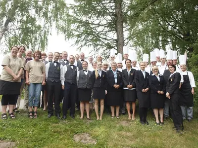 a group of people in suits and ties posing for a picture at Rold StorKro in Skorping