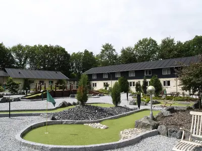 a golf course in front of a building at Rold StorKro in Skorping