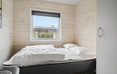 a bed in a room with a window at Three-Bedroom Holiday Home In Vestervig in Vestervig