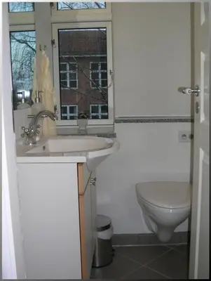a bathroom with a sink and a toilet at Klosterpensionen in Viborg