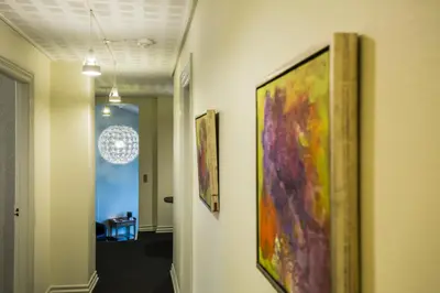 a hallway with three paintings on the walls at Bed & Breakfast Holstebro in Holstebro