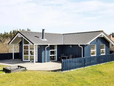 a blue house with a fence in front of it at Luxury Retreat in Vorupor - By Traum Ferienwohnungen in Nørre Vorupør