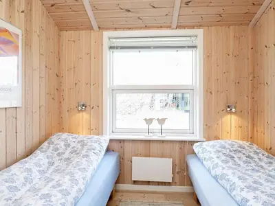 a bedroom with two beds and a window with two glasses at Luxury Retreat in Vorupor - By Traum Ferienwohnungen in Nørre Vorupør