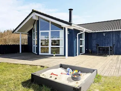 a house with a sandbox in the yard at Luxury Retreat in Vorupor - By Traum Ferienwohnungen in Nørre Vorupør