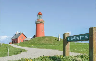a lighthouse on top of a hill with a street sign at 2 Bedroom Lovely Apartment In Lemvig in Lemvig