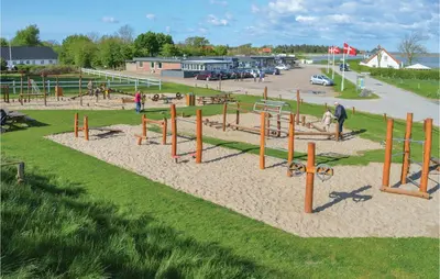 a playground with play equipment in a park at 2 Bedroom Lovely Apartment In Lemvig in Lemvig