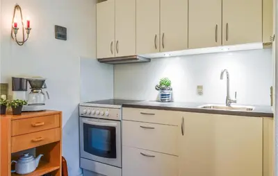 a kitchen with white cabinets and a sink at 2 Bedroom Lovely Apartment In Lemvig in Lemvig